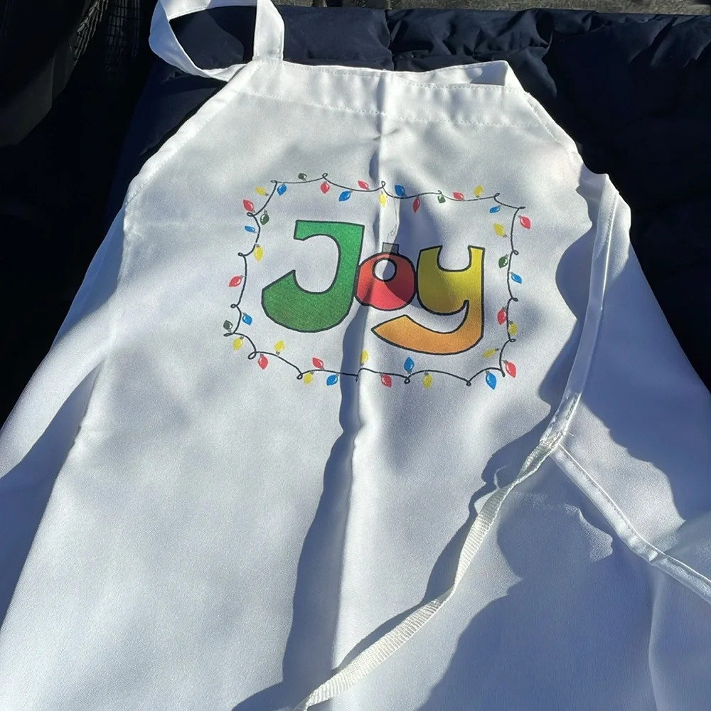 Apron, Xmas themed with “Joy”, Xmas lights/bulb. Full sized apron, ties in back